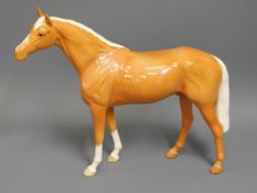 A large Beswick palomino horse, 11in tall