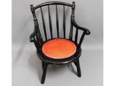 A lacquered cut down nursing chair, 28in high