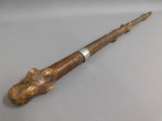 A knobbly walking cane with silver collar inscribe