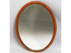 A c.1900 inlaid mahogany oval hall mirror with bev