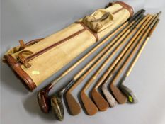 A leather & canvas bag with hickory golf clubs inc