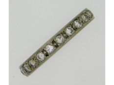 A white metal, electronically tests as platinum, eternity ring set with approx. 1.1ct diamond, 3.9g,