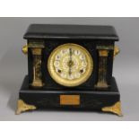 A wooden mantel clock with gilt fittings, some wor