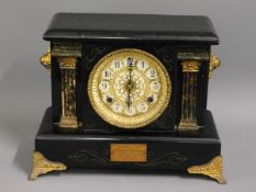 A wooden mantel clock with gilt fittings, some wor