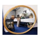 A very large 19thC. gesso framed oval mirror, 64in