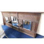 A large, heavily carved oak over mantle mirror, 71