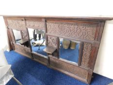 A large, heavily carved oak over mantle mirror, 71