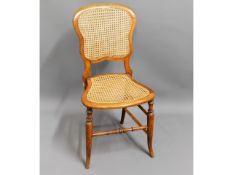 An antique cane seated bedroom chair, 33in high