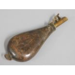 A 19thC. leather & brass powder flask, 9in long