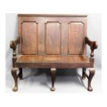 An antique oak settle with cushion, 43.5in wide x