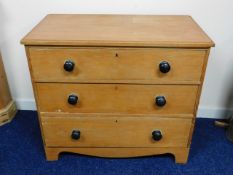 A low level 19thC. three drawer pine chest, 33.5in wide x 29in high x 18.5in deep