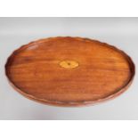 A large 19thC. mahogany tea tray with inlaid decor