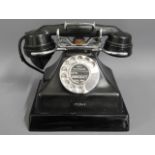 A vintage bakelite telephone, no. AP12688