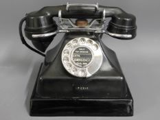 A vintage bakelite telephone, no. AP12688