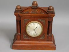 A wooden electric clock, 10.75in high
