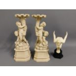 A pair of ornate resin candle holders, 15in high,