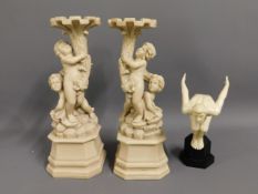 A pair of ornate resin candle holders, 15in high,