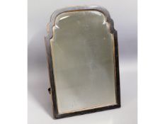An antique ornately framed free standing mirror wi