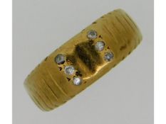 A 9ct gold band set with six small diamonds, 2.2g,