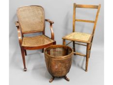 A cane armchair twinned with a chair bedroom chair & a cane basket