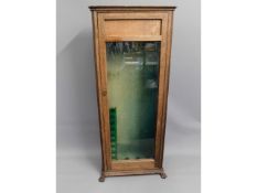 A glazed oak gun cabinet with claw feet, 61.5in hi