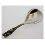 An arts & crafts style caddy spoon, tests as silve