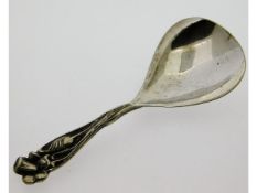 An arts & crafts style caddy spoon, tests as silve