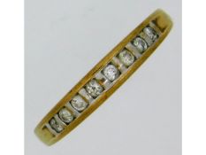 A yellow metal, tests as 9ct gold, half eternity ring set with 0.25ct diamond, 1.93g, size T