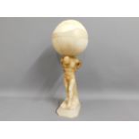 An art deco style alabaster lamp featuring Atlas,