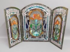 A stained glass triptych depicting floral decor, 2