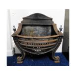 A decorative cast iron fire basket, maker "Manor",