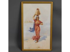 A framed middle eastern watercolour of woman carry