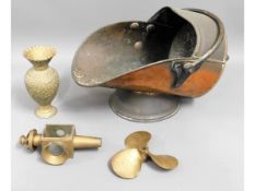 A copper coal scuttle, a bronze propeller, a brass