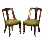 Two late Victorian walnut 'Athenium' style chairs, each with green leatherette seat (2) Condition: