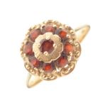 Yellow metal cluster ring set red stones, shank stamped 585, size Q½, 3.4g gross approx