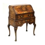 Early 20th Century walnut veneered bureau, the hinged flap opening to reveal a fitted interior and
