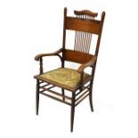Early 20th Century oak occasional armchair with padded seat, 104cm high approx Condition: Wear