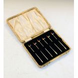 Set of six mid 20th Century white metal cocktail sticks, each decorated with an enamelled