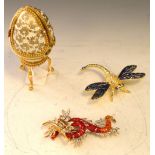 Costume jewellery - dragon brooch, a similar dragonfly ornament and a Faberge style egg on stand