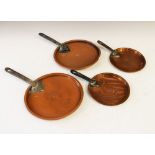 Four Victorian copper pan lids, the two largest measuring 35cm with handle and marked VR8, the