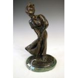 Late 20th Century bronzed figure of an Edwardian lady golfer, standing on a green marble base,
