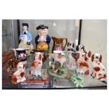 Quantity of Staffordshire pottery and other figures to include spaniels, cow and calf figure