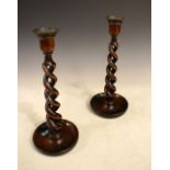 Pair of early 20th Century oak spiral twist candlesticks, 32cm high Condition: **General condition