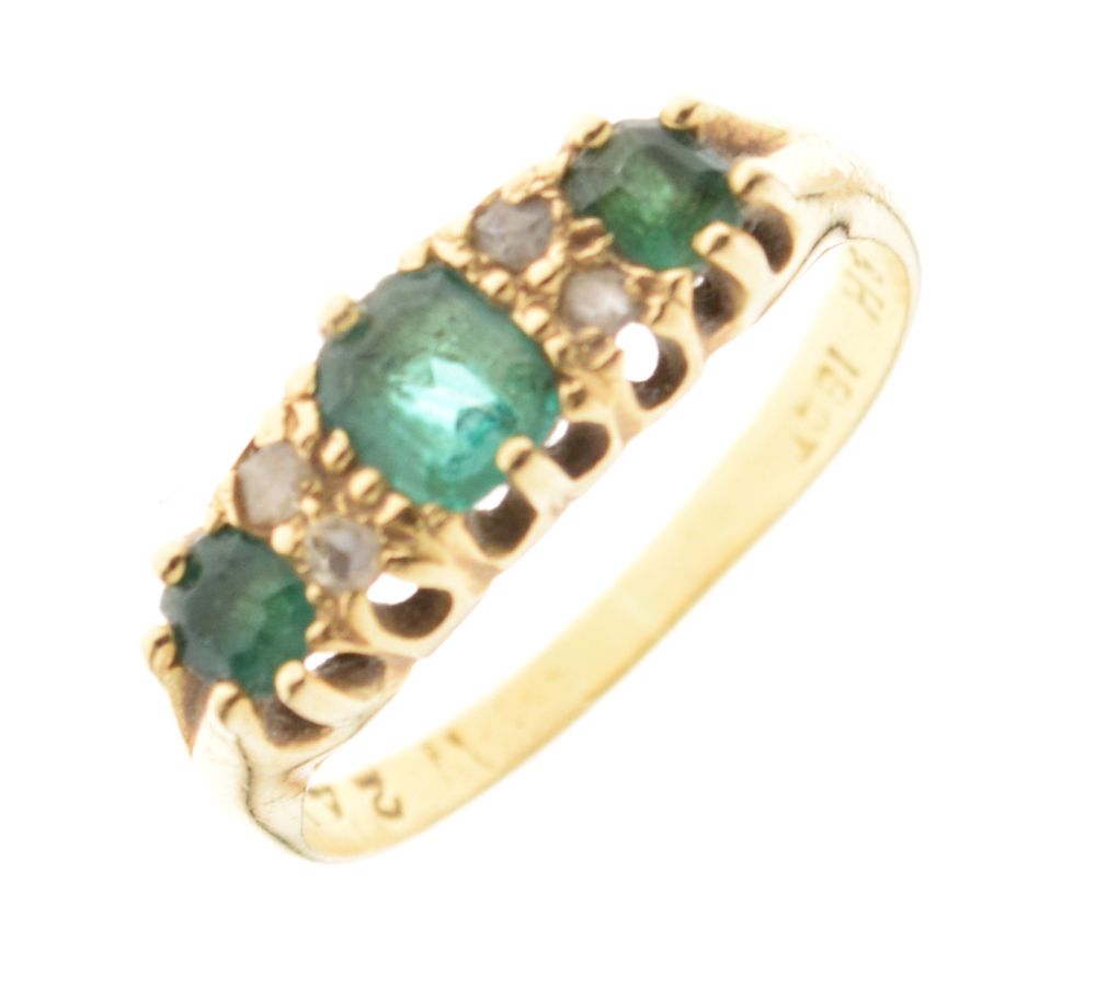Yellow metal dress ring set three green and four small white stones, the shank stamped 18ct, size P,
