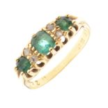 Yellow metal dress ring set three green and four small white stones, the shank stamped 18ct, size P,