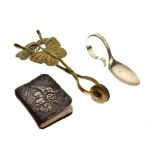 Vintage brass skirt-lifter of butterfly design, together with a child's silver feeding spoon, cased,