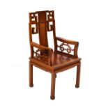 Chinese hardwood armchair, having geometric decoration and bearing label for George Zee & Co Ltd,