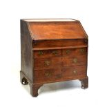 Mid 18th Century oak bureau, fitted drawers and pigeon holes over retractable well, the front of two