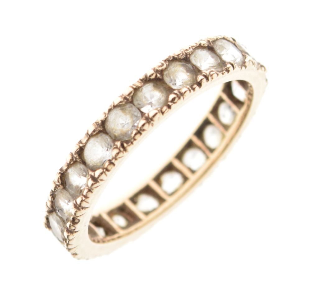 Unmarked yellow metal eternity ring set white stones, size M, 2.2g gross approx Condition: Light