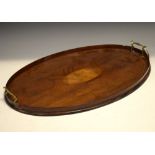 Edwardian mahogany and string inlaid oval tray fitted two brass carry handles, 62cm wide